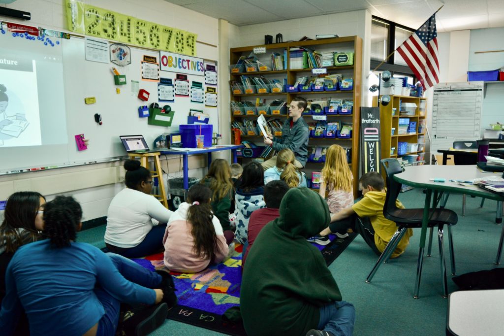 Teacher reading to students at Northwest school